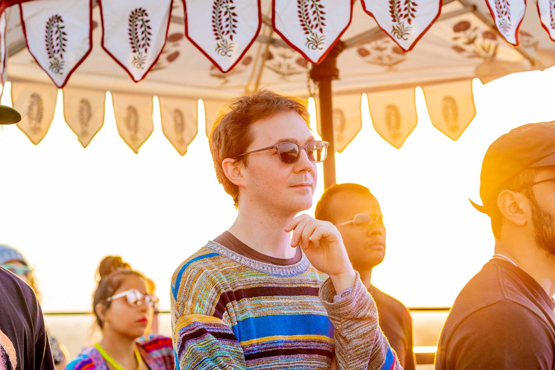 Ben UFO watching the folk musicians perform on the Puqaar stage at Magnetic Fields - Image - Abhishek Shukla